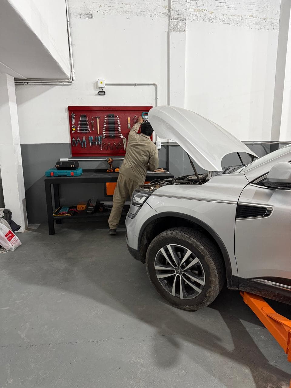 Mecánico de Magari Service trabajando sobre el motor de un Renault Koleos