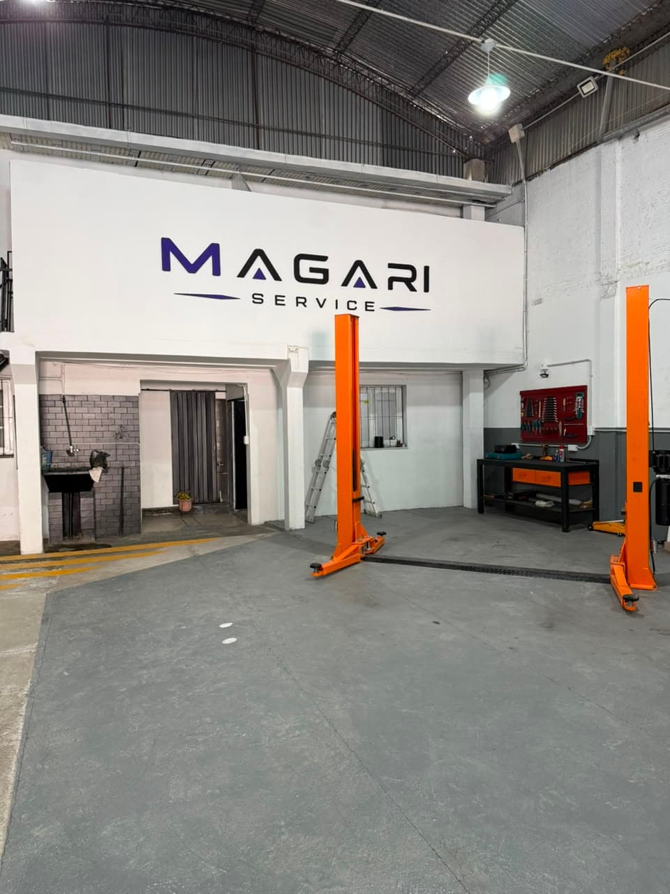 Interior del taller Magari Service con dos elevadores de columnas